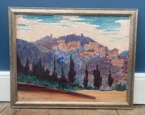 fig 1. An early twentieth-century oil painting on canvas depicting an Italian hillside village framed by cypress trees, rendered in shades of purple, turquoise, and ochre, signed Christopher Williams in the lower left corner.