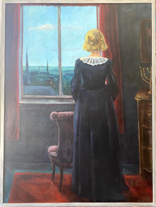fig 1. An oil on board painting from 1938 depicting a woman in a dark dress standing by a window framed with red curtains and looking out at a town skyline.