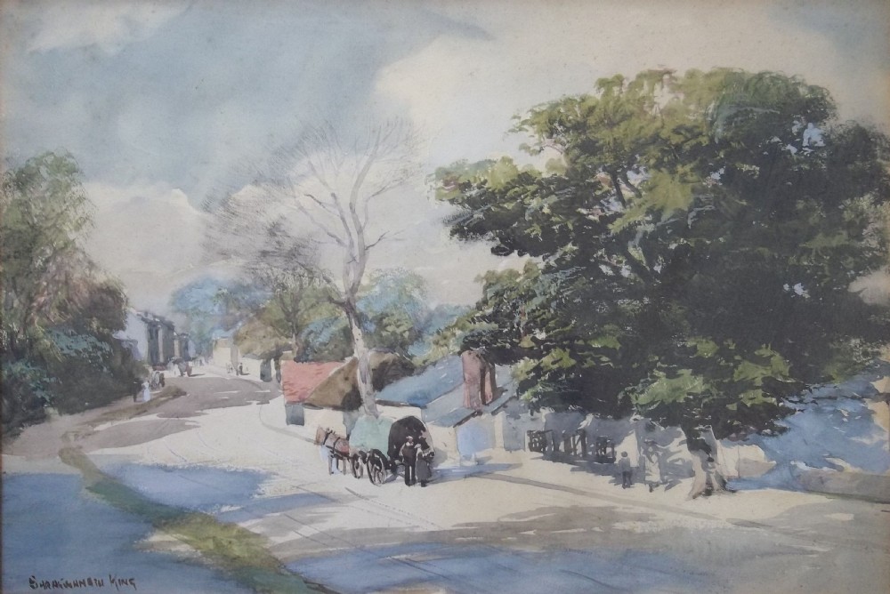 A late 19th-century watercolour painting depicting a village street in Cornwall with cottages, a horse-drawn cart, and large leafy trees under an overcast sky.