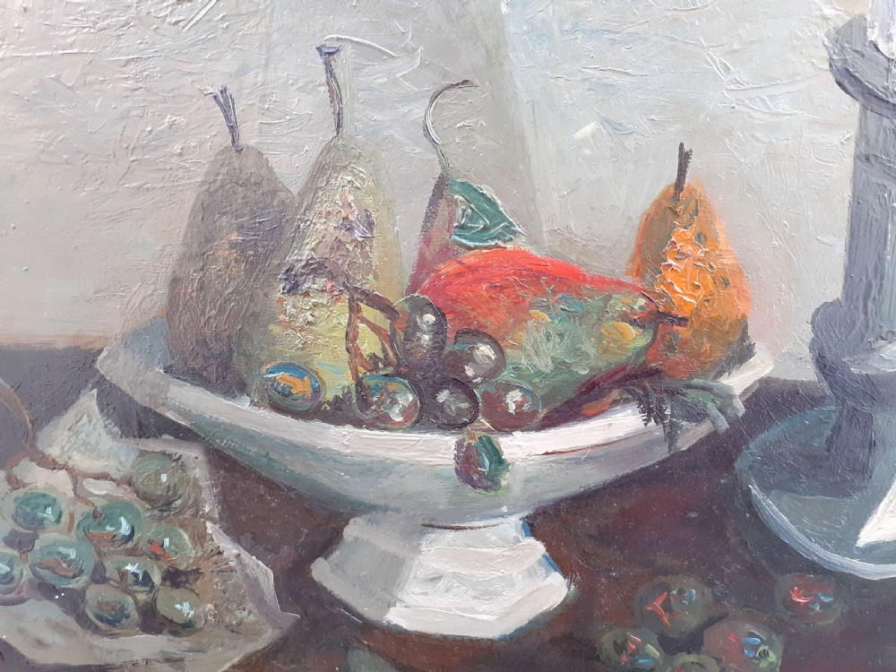 A mid-century French modernist oil painting on canvas depicting a ceramic bowl with pears, bunches of grapes, and a candlestick on a table against a textured grey background. View III