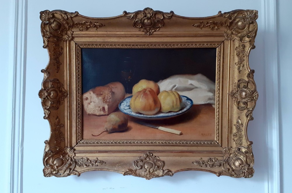 A mid-19th-century oil painting on canvas depicting a rustic still life with bread, fruit on a ceramic plate, a pear, and a knife, housed in an ornate carved gold frame. View II