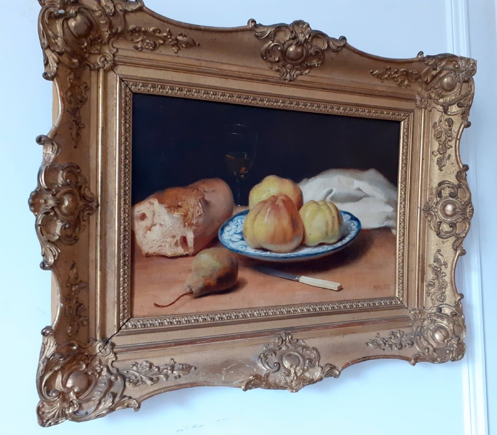 A mid-19th-century oil painting on canvas depicting a rustic still life with bread, fruit on a ceramic plate, a pear, and a knife, housed in an ornate carved gold frame. View III