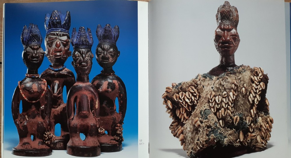 Three hand-carved dark wood Yoruba Ere Ibeji figures featuring tall indigo-pigmented coiffures, carved facial scarification, and glass waist beads. View IX