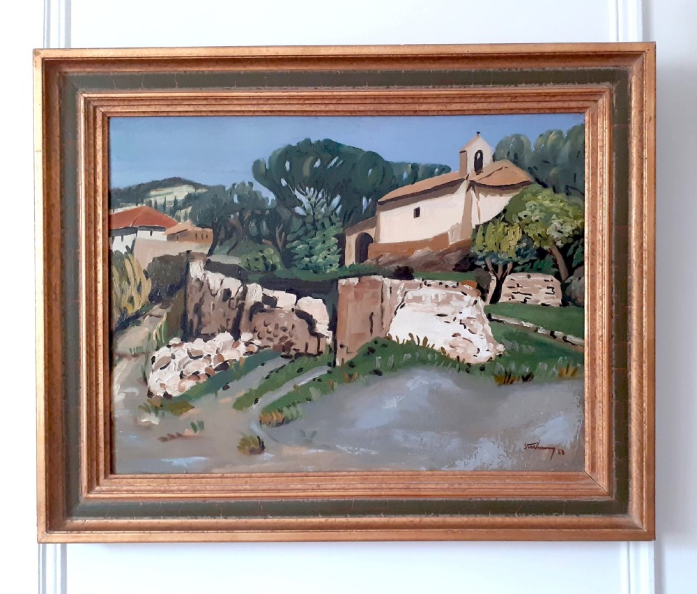 A mid-century oil painting on canvas depicting a Provencal landscape with a white chapel, craggy stone walls, olive trees, and a soft blue sky. View IV