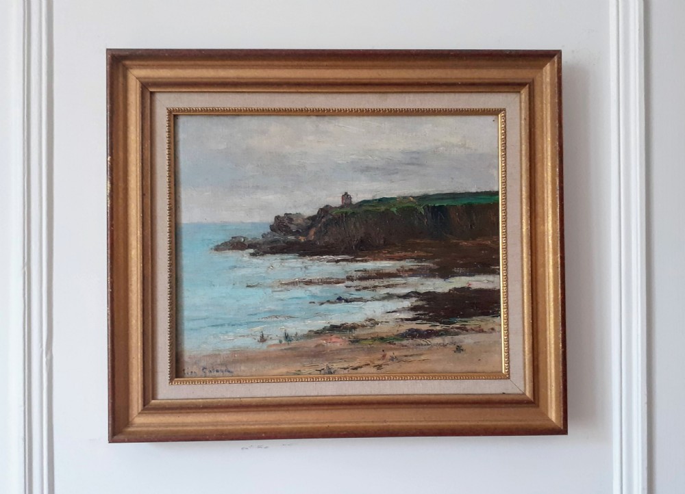 A framed oil painting depicting a French coastal seascape with dark cliffs, blue water, and a small lighthouse on a grassy hilltop under an overcast sky. View II