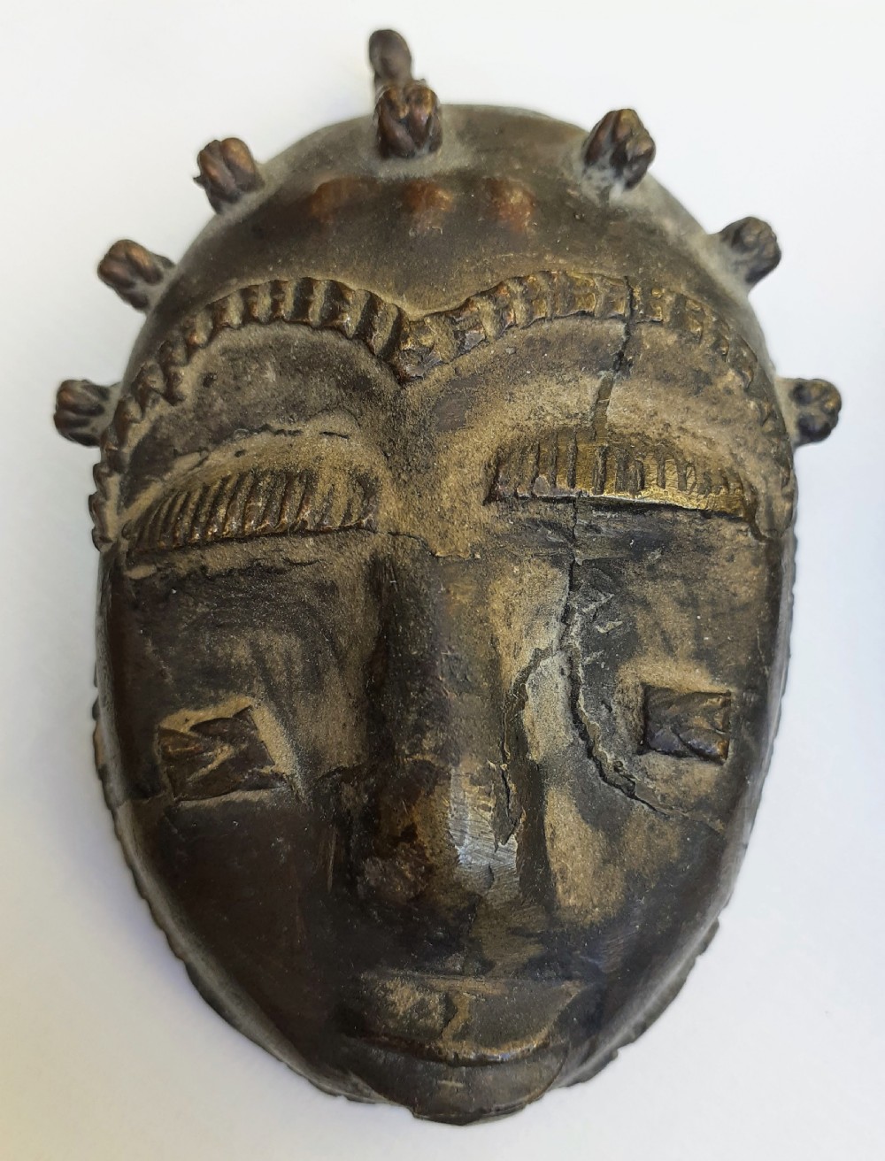 A pair of antique Ashanti African bronze miniature mask pendants, in lost wax technique, Ghana Africa View II