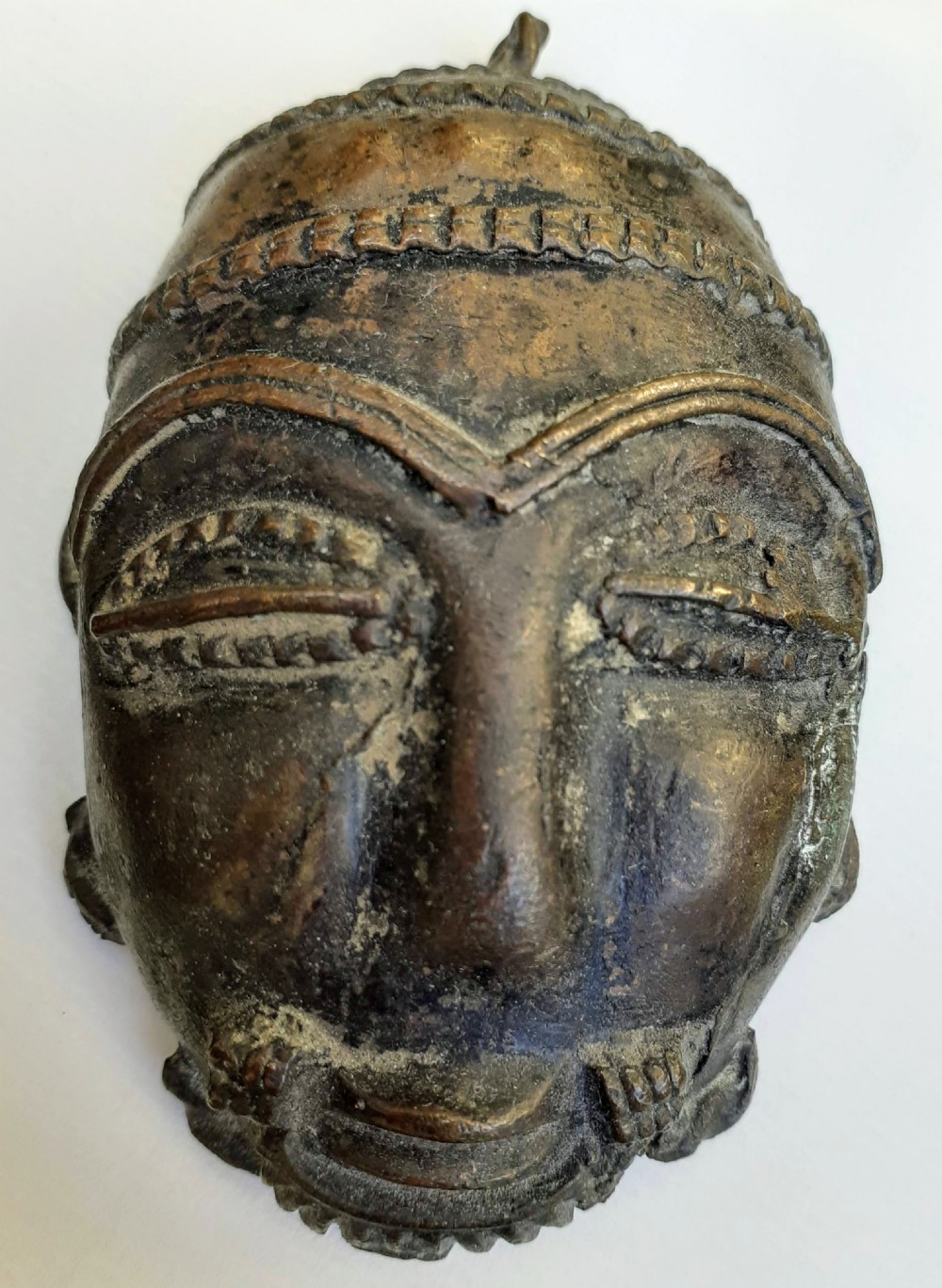 A pair of antique Ashanti African bronze miniature mask pendants, in lost wax technique, Ghana Africa View III