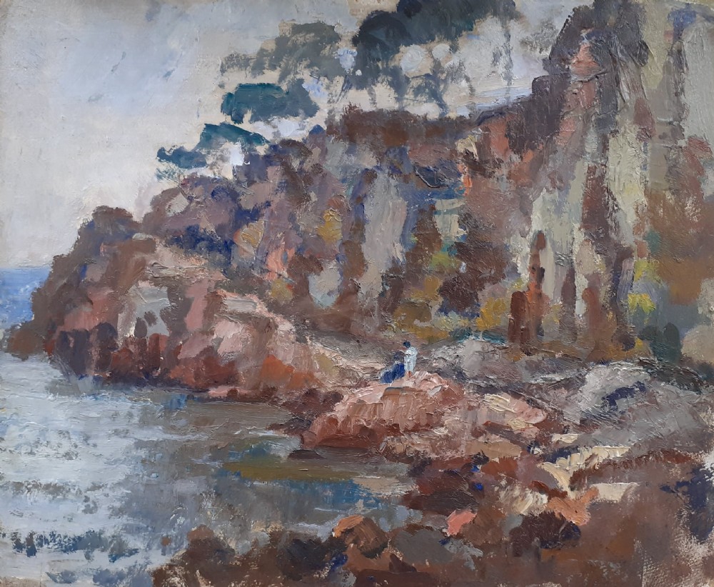 An early 20th-century oil painting on board depicting rocky Mediterranean coastal cliffs with small figures resting near the water under a cloudy sky.
