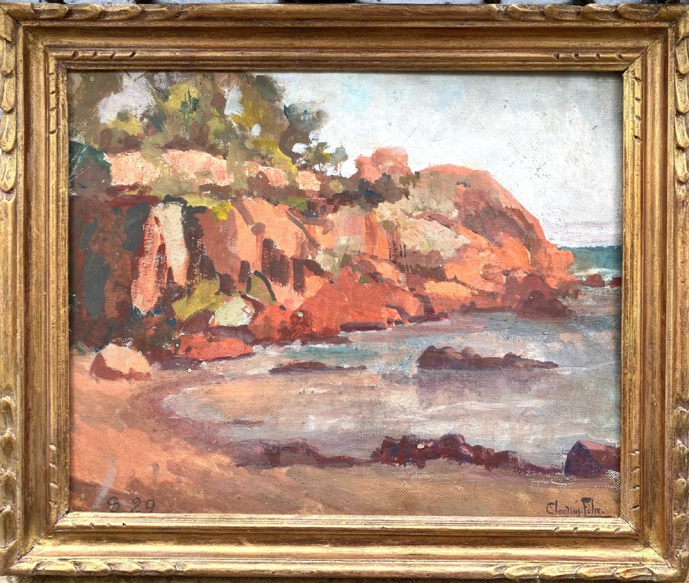 An early 20th-century oil painting on board depicting rocky Mediterranean coastal cliffs with small figures resting near the water under a cloudy sky. View VII