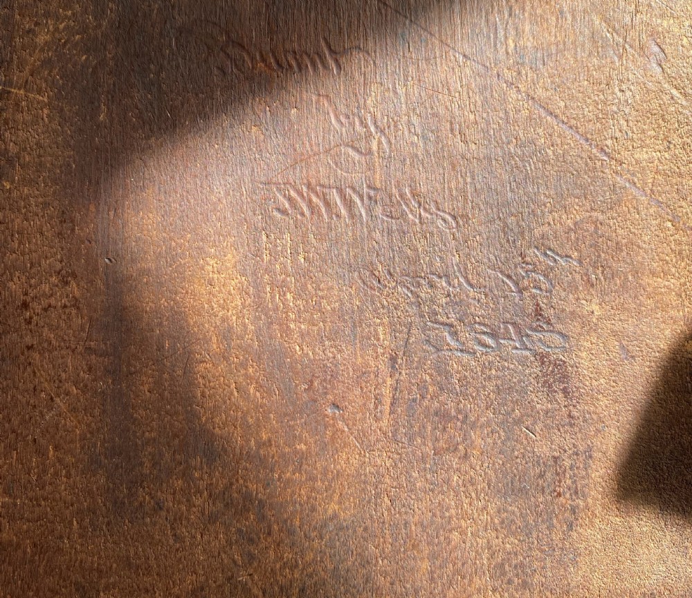An antique rectangular wooden panel featuring a pyrography pokerwork profile portrait of a bearded man holding a book. View VI
