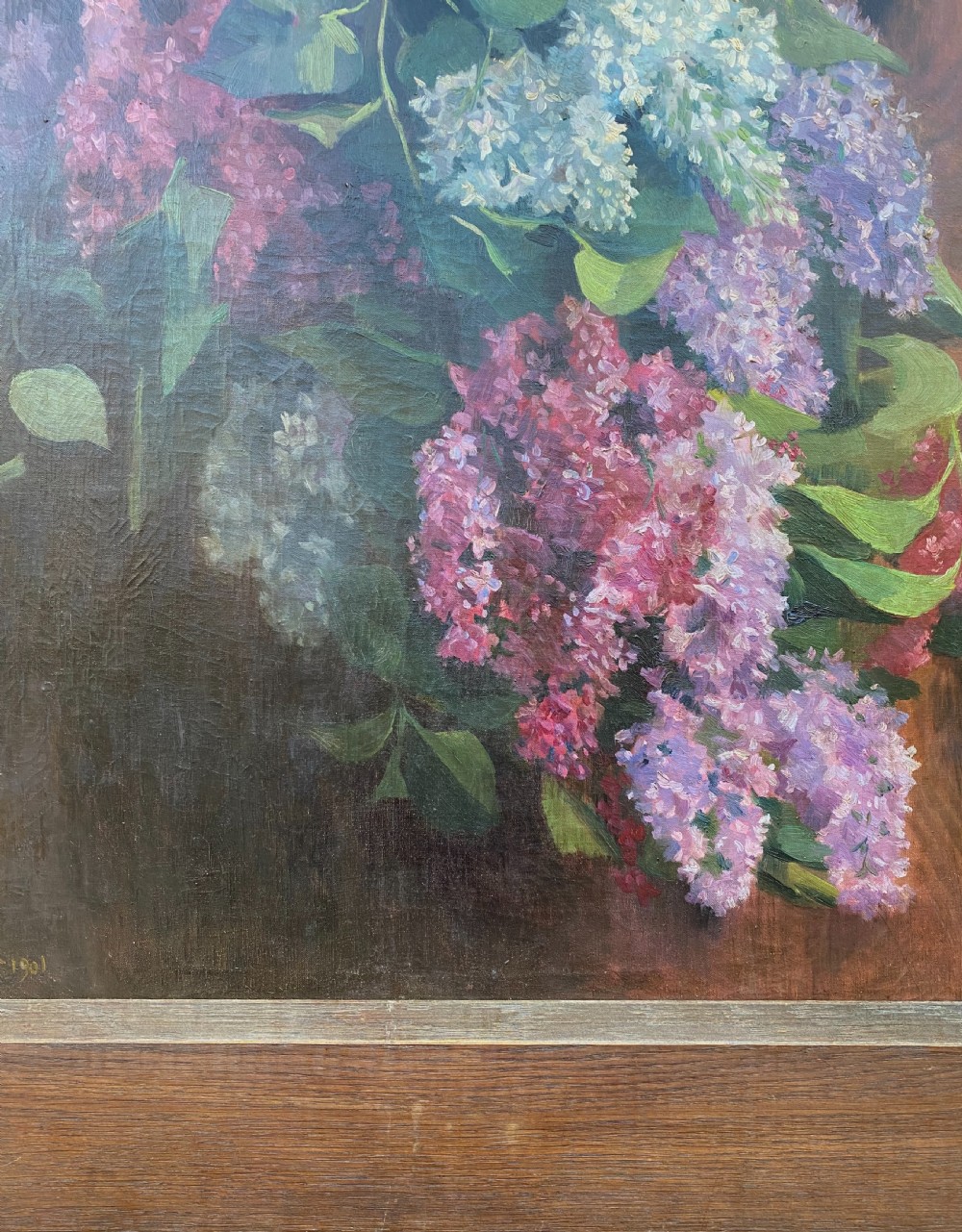 An oil on canvas painting dated 1901 depicting a bouquet of purple and white lilac flowers hanging against a dark oak wooden door. View II