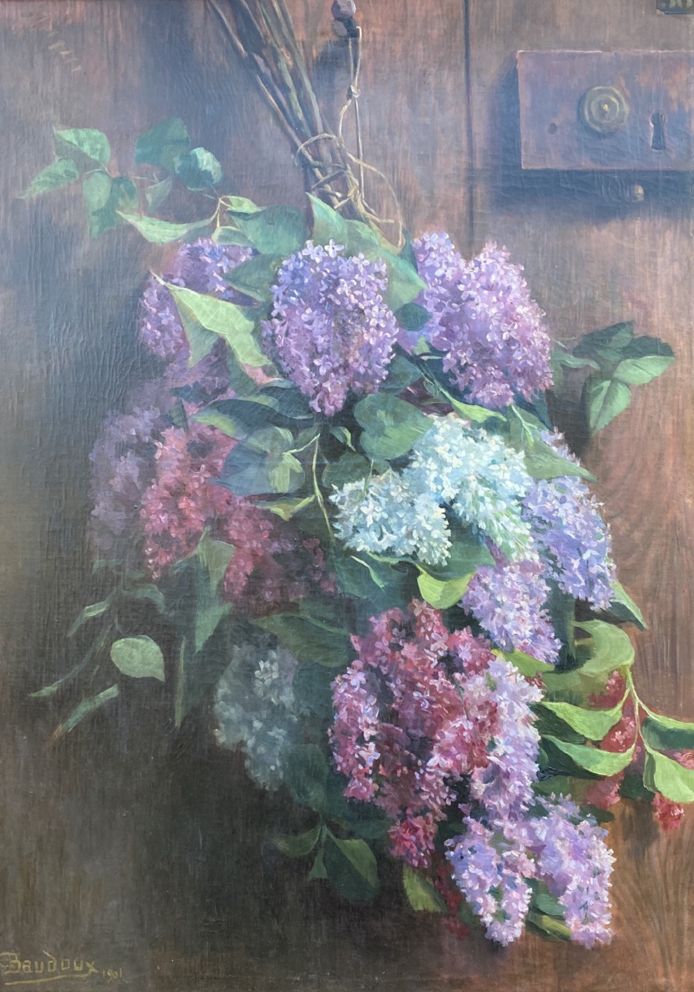 An oil on canvas painting dated 1901 depicting a bouquet of purple and white lilac flowers hanging against a dark oak wooden door.