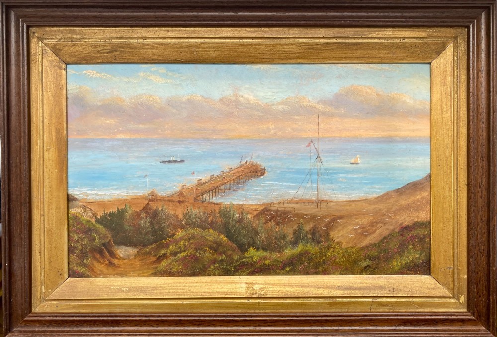 Victorian topographical oil painting on board depicting Boscombe Pier in Dorset with steamships on blue water and coastal cliffs in the foreground. View II