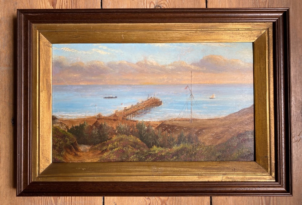 Victorian topographical oil painting on board depicting Boscombe Pier in Dorset with steamships on blue water and coastal cliffs in the foreground. View III