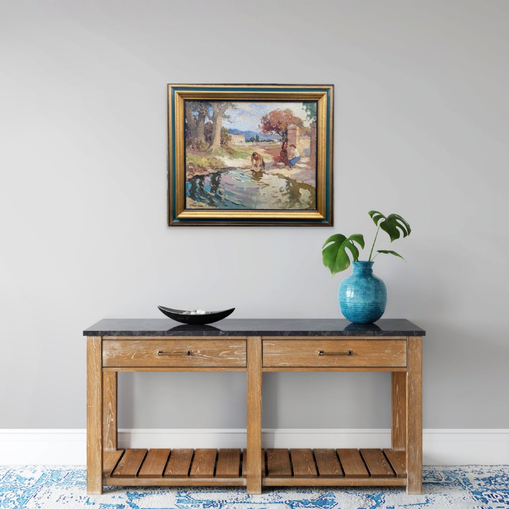 A mid-century French oil painting depicting two washerwomen working beside a reflecting stream in a sunlit Provencal countryside landscape. View VI