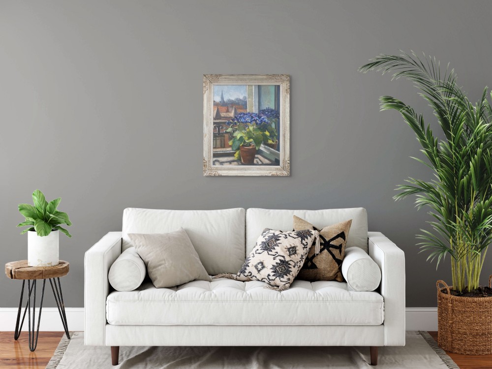 An oil painting on canvas depicting blue potted flowers sitting on a window sill overlooking a European rooftop view, housed in a carved cream wood frame. View VI