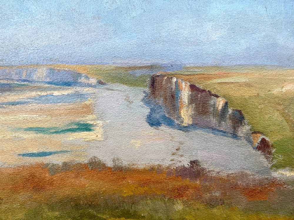 An early twentieth-century French oil painting on board depicting coastal cliffs overlooking a calm sea in Normandy under a muted sky. View IV