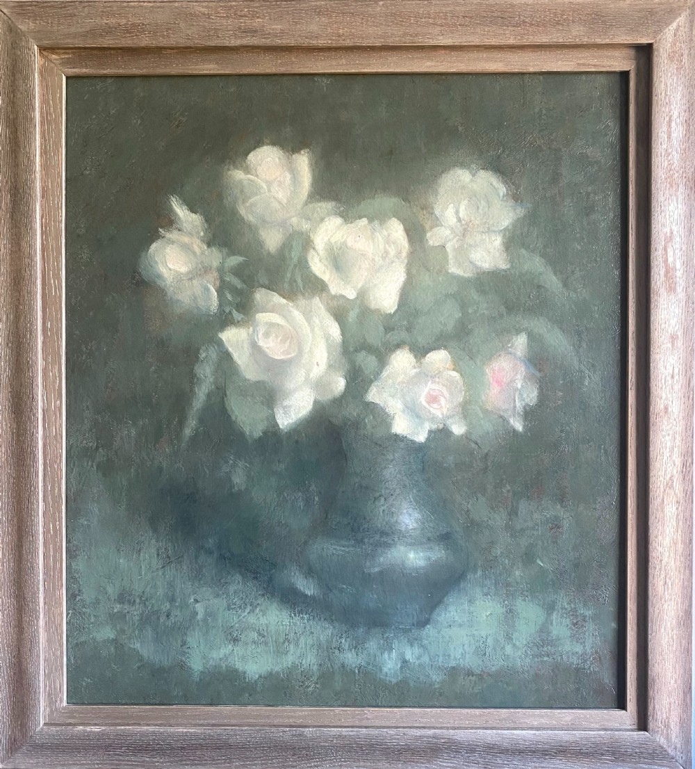 An antique early twentieth-century oil painting on board depicting pale white roses in a dark vase set against a muted green background. View II