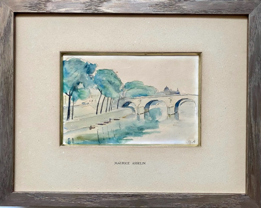 A framed watercolour painting depicting the River Seine, trees, and the Pont Marie bridge in Paris executed in soft blue and green washes.
