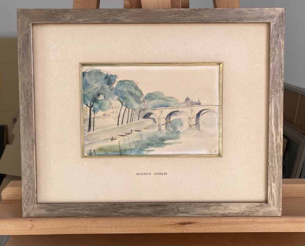 A framed watercolour painting depicting the River Seine, trees, and the Pont Marie bridge in Paris executed in soft blue and green washes. View V
