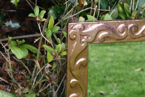 ARTS AND CRAFTS COPPER MIRROR DECORATED WITH A DESIGN OF LINKED SCROLLS - ADDITIONAL PHOTO 1