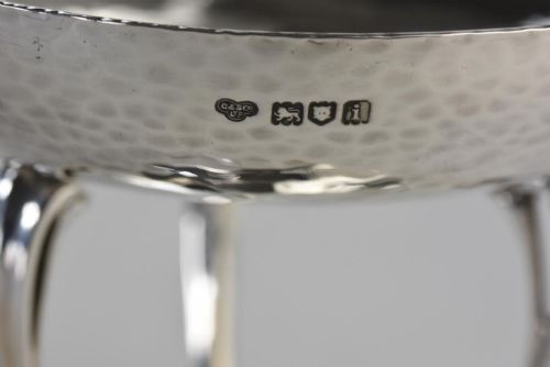 fig 2. A hand-hammered sterling silver tazza dish supported by three curved legs attached to a round raised base.