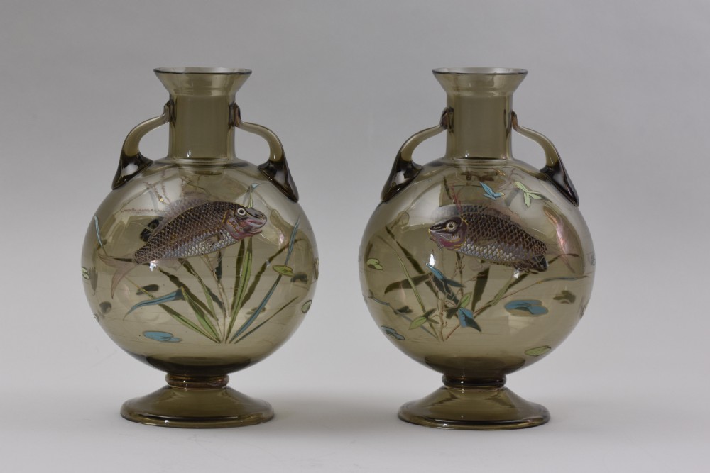 Pair of translucent smoky brown glass vases featuring twin loop handles, pedestal bases, and hand-painted enamelled motifs of blue fish and water plants. View II