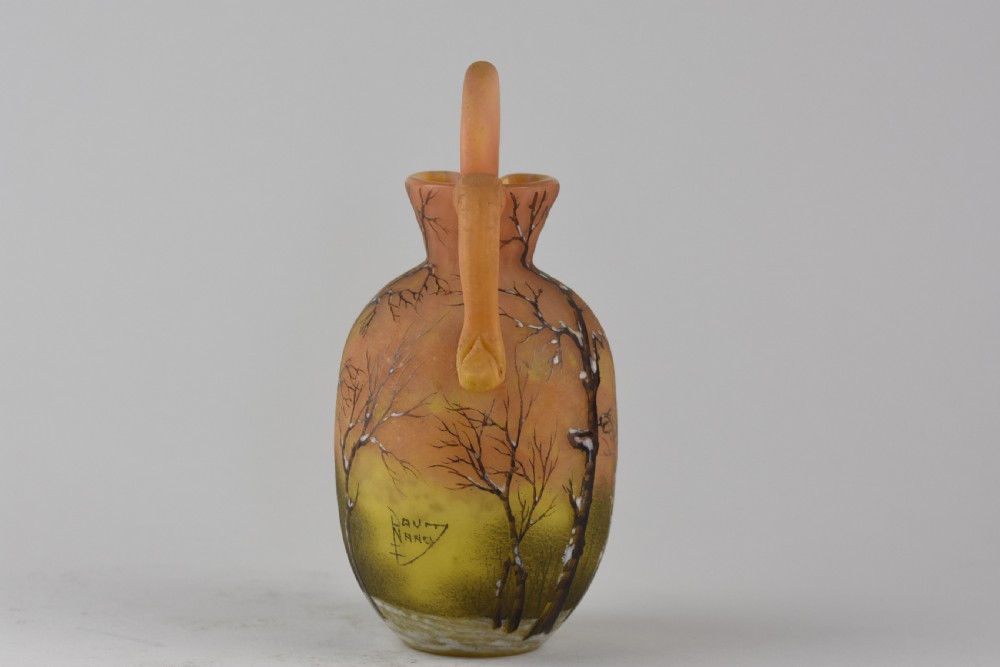 An Art Nouveau Daum Nancy glass jug featuring acid-etched and enamelled winter landscape decoration on an orange gradient background, complete with a spherical stopper. View II