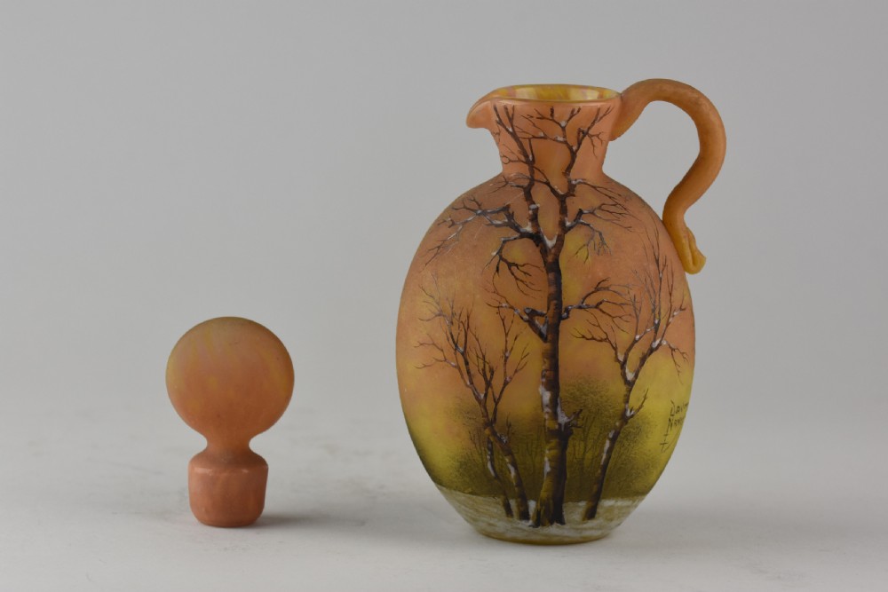 An Art Nouveau Daum Nancy glass jug featuring acid-etched and enamelled winter landscape decoration on an orange gradient background, complete with a spherical stopper. View III