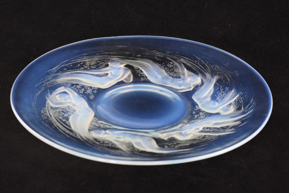 A circular opalescent glass plate featuring press-moulded relief figures of swimming nymphs amidst swirling water motifs. View II