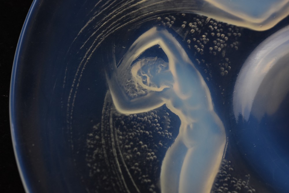 A circular opalescent glass plate featuring press-moulded relief figures of swimming nymphs amidst swirling water motifs. View IV