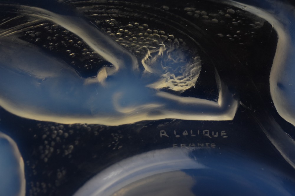 A circular opalescent glass plate featuring press-moulded relief figures of swimming nymphs amidst swirling water motifs. View VI