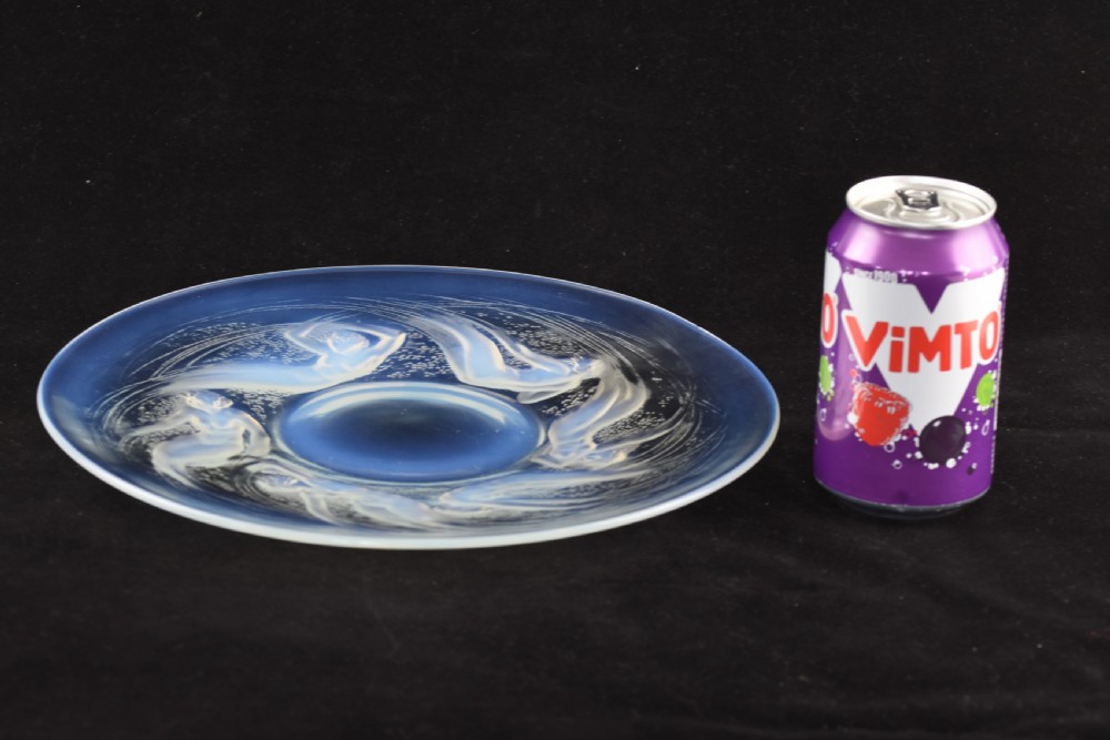 A circular opalescent glass plate featuring press-moulded relief figures of swimming nymphs amidst swirling water motifs. View VIII
