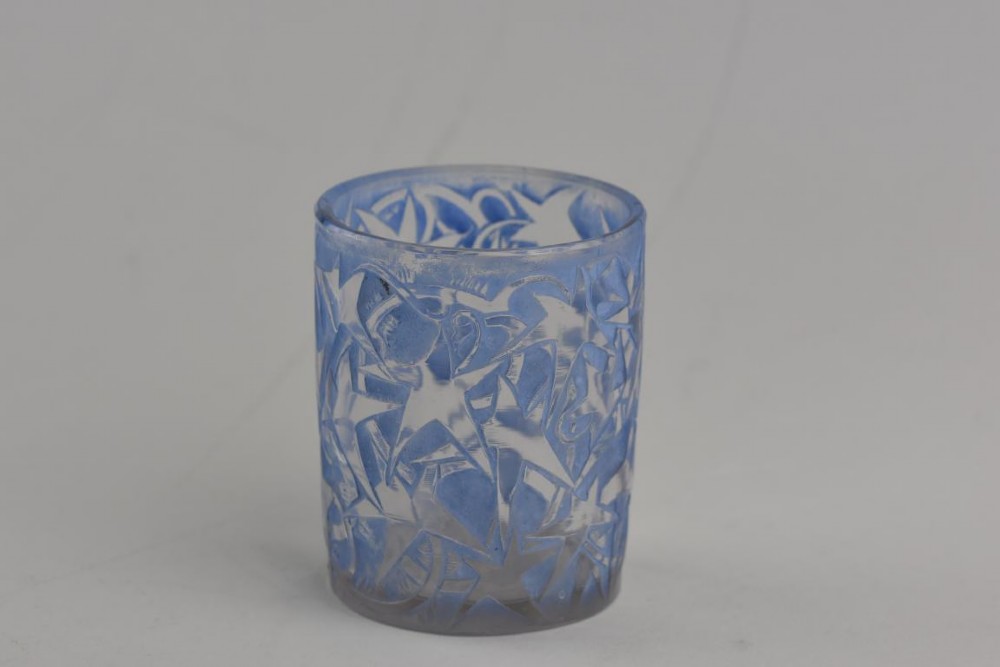 A small cylindrical clear and frosted glass vessel decorated with an embossed ivy motif highlighted with blue stain. View II