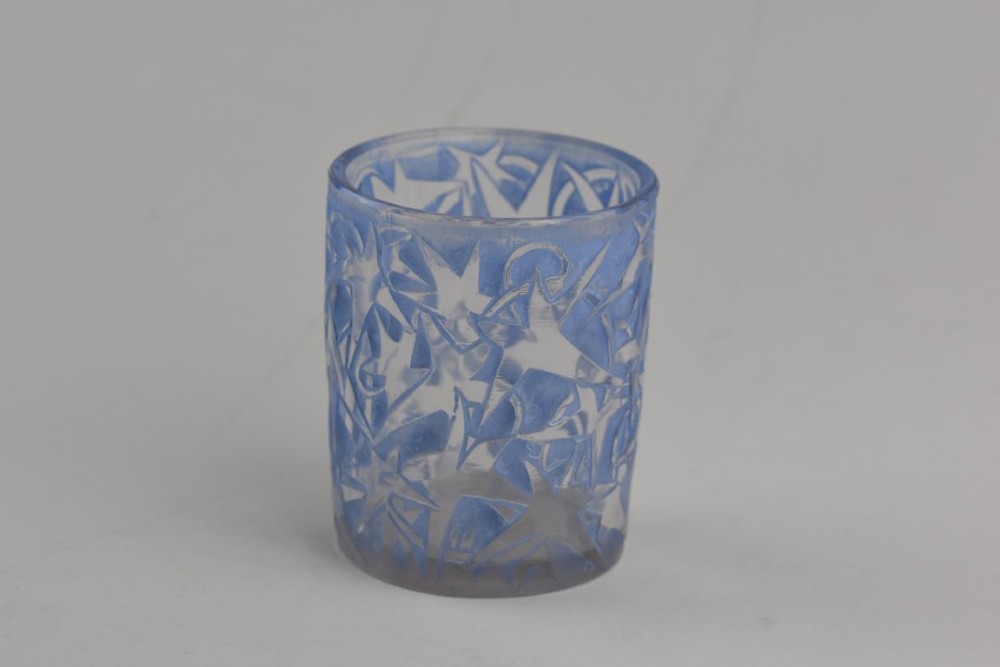 A small cylindrical clear and frosted glass vessel decorated with an embossed ivy motif highlighted with blue stain. View III