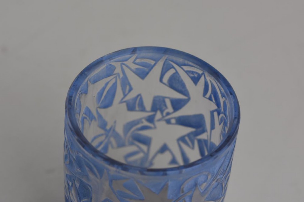 A small cylindrical clear and frosted glass vessel decorated with an embossed ivy motif highlighted with blue stain. View IV