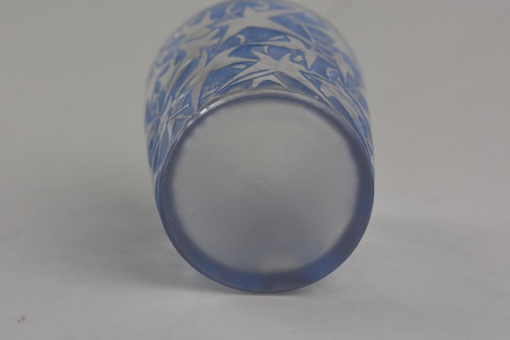 A small cylindrical clear and frosted glass vessel decorated with an embossed ivy motif highlighted with blue stain. View V