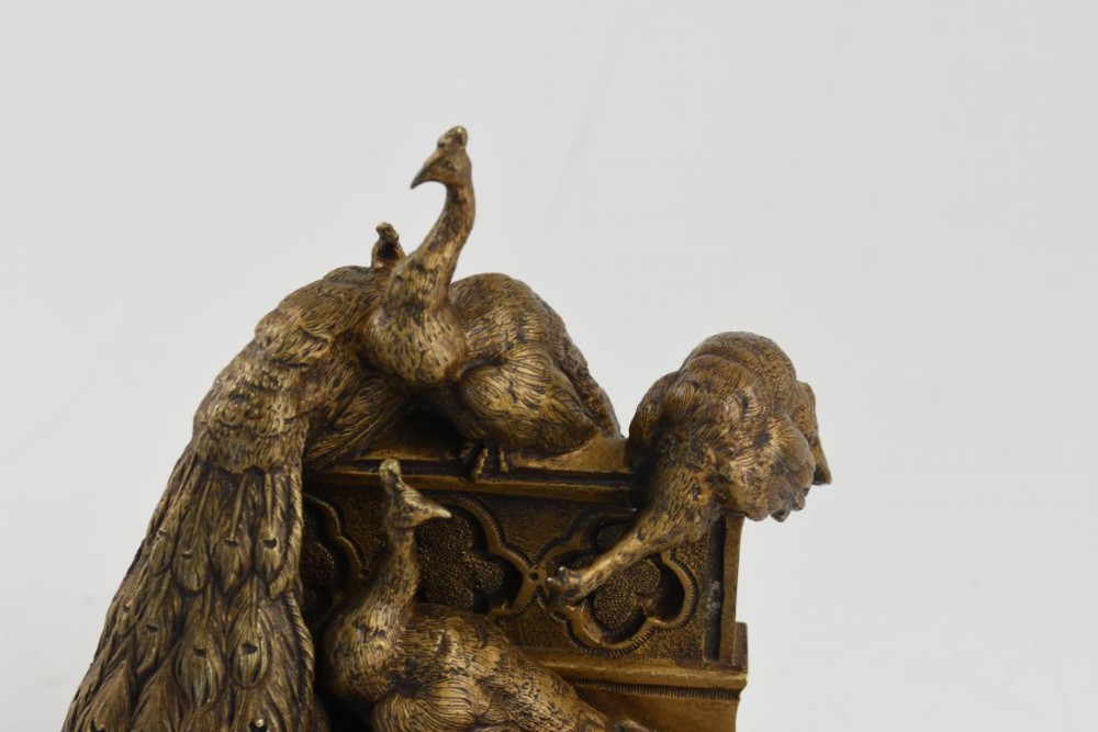 A French Art Nouveau patinated bronze sculpture depicting five peacocks perched around a carved balustrade. View V