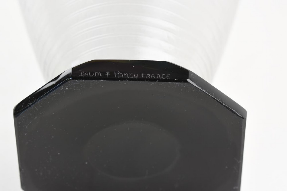 A ribbed grey glass vase with a flared rim resting on an octagonal black base. View IV