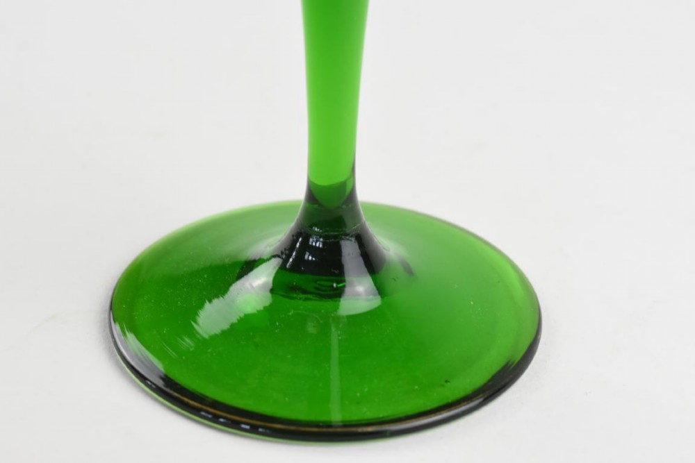 An Art Nouveau wine glass featuring an elongated green stem and a clear bowl decorated with pink and green enamelled floral motifs. View IV