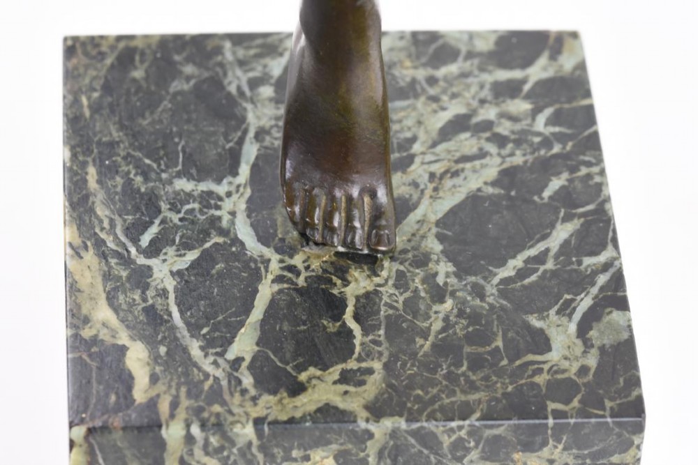 An Art Deco dark patinated bronze figure of a female dancer holding cymbals, balanced on one leg atop a tall green-veined marble base. View VII