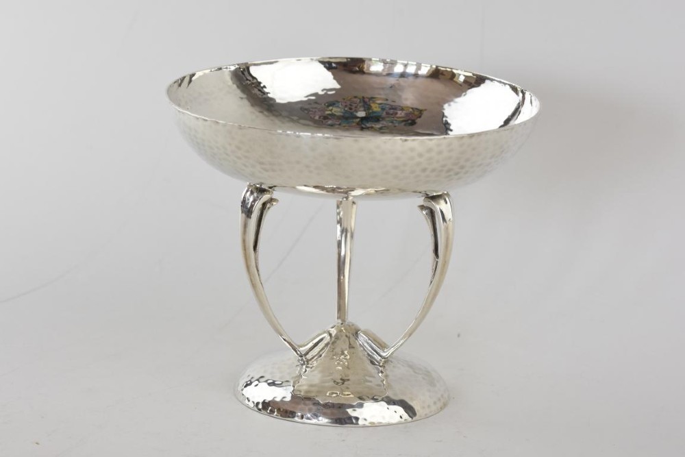 A hand-hammered sterling silver tazza dish supported by three curved legs attached to a round raised base.
