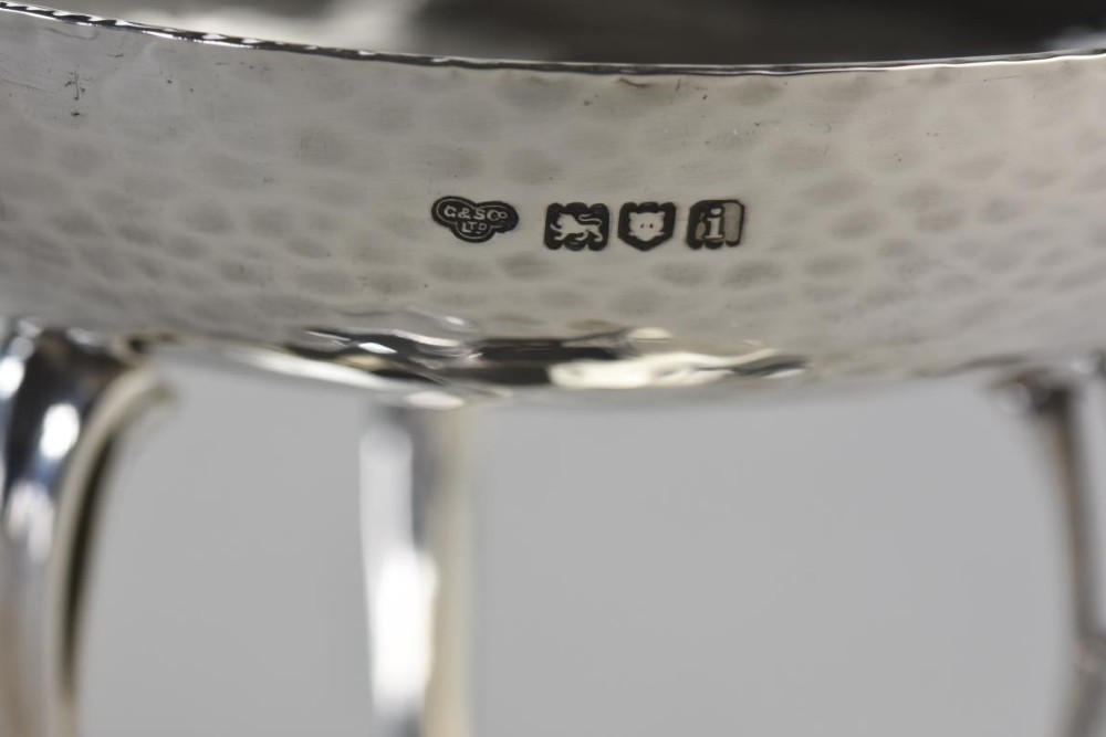 A hand-hammered sterling silver tazza dish supported by three curved legs attached to a round raised base. View III