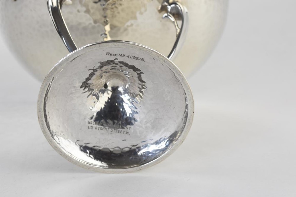 A hand-hammered sterling silver tazza dish supported by three curved legs attached to a round raised base. View IV