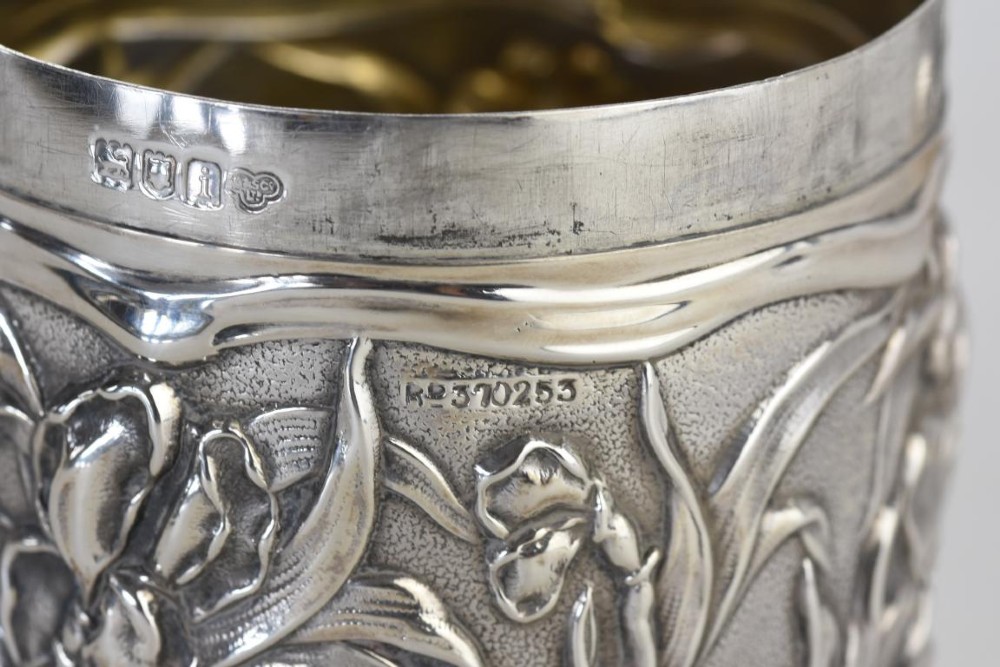 A cylindrical Art Nouveau sterling silver box with a fitted lid, decorated with raised repousse iris motifs. View V