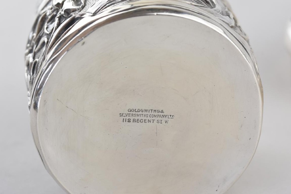 A cylindrical Art Nouveau sterling silver box with a fitted lid, decorated with raised repousse iris motifs. View VII
