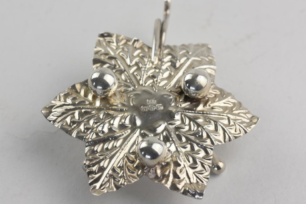 A pair of Aesthetic Period silver salt cellars with leaf-shaped bases, clear glass lotus liners, matching silver spoons, housed in a fitted velvet presentation case. View IV