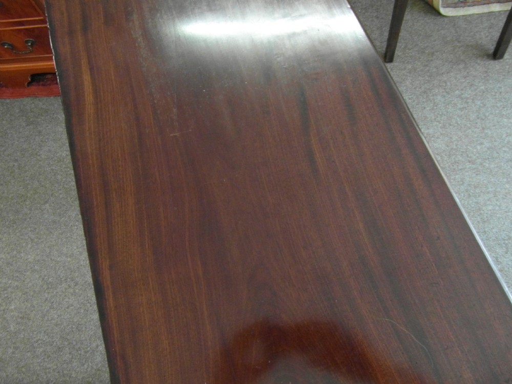 A Georgian dark mahogany lowboy featuring three drawers with brass handles, a shaped lower apron, and cabriole legs ending in pad feet. View II