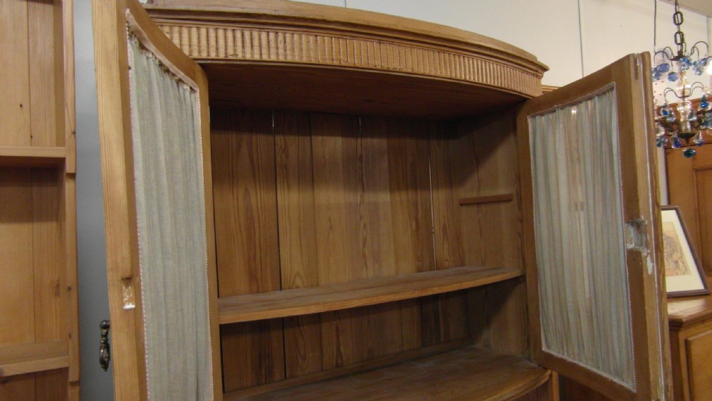 A Victorian pine kitchen dresser featuring an upper two-door cabinet with pleated fabric panels over a base unit with two drawers and two cupboard doors. View V