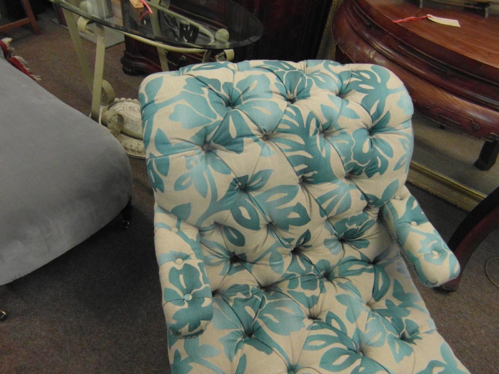 A Victorian upholstered chaise longue featuring deep-buttoned tufting in a teal and cream floral pattern with short turned wooden legs. View III